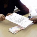 Resume or CV paper. Applicant’s hand giving resume to employer for review the profile of the applicant.